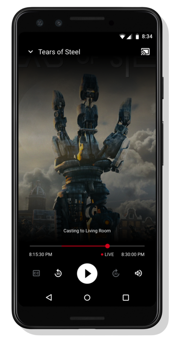Android फ़ोन पर वीडियो चलाते हुए दिखाया गया है; &#39;लिविंग रूम में कास्ट किया जा रहा है&#39; मैसेज वीडियो प्लेयर कंट्रोल के सेट के ठीक ऊपर, सबसे नीचे दिखता है