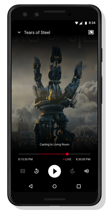 動画を再生している Android スマートフォンの画像。動画プレーヤー コントロールのセットのすぐ下に「リビングにキャストしています」というメッセージが表示されます。